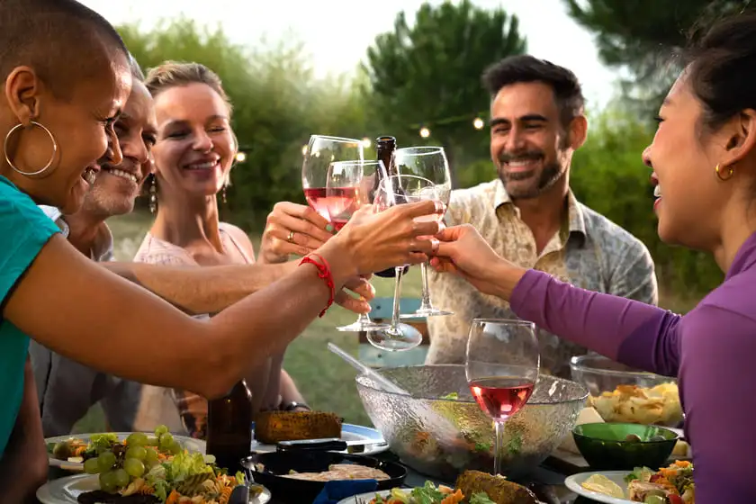 diverse happy friends toasting with wine